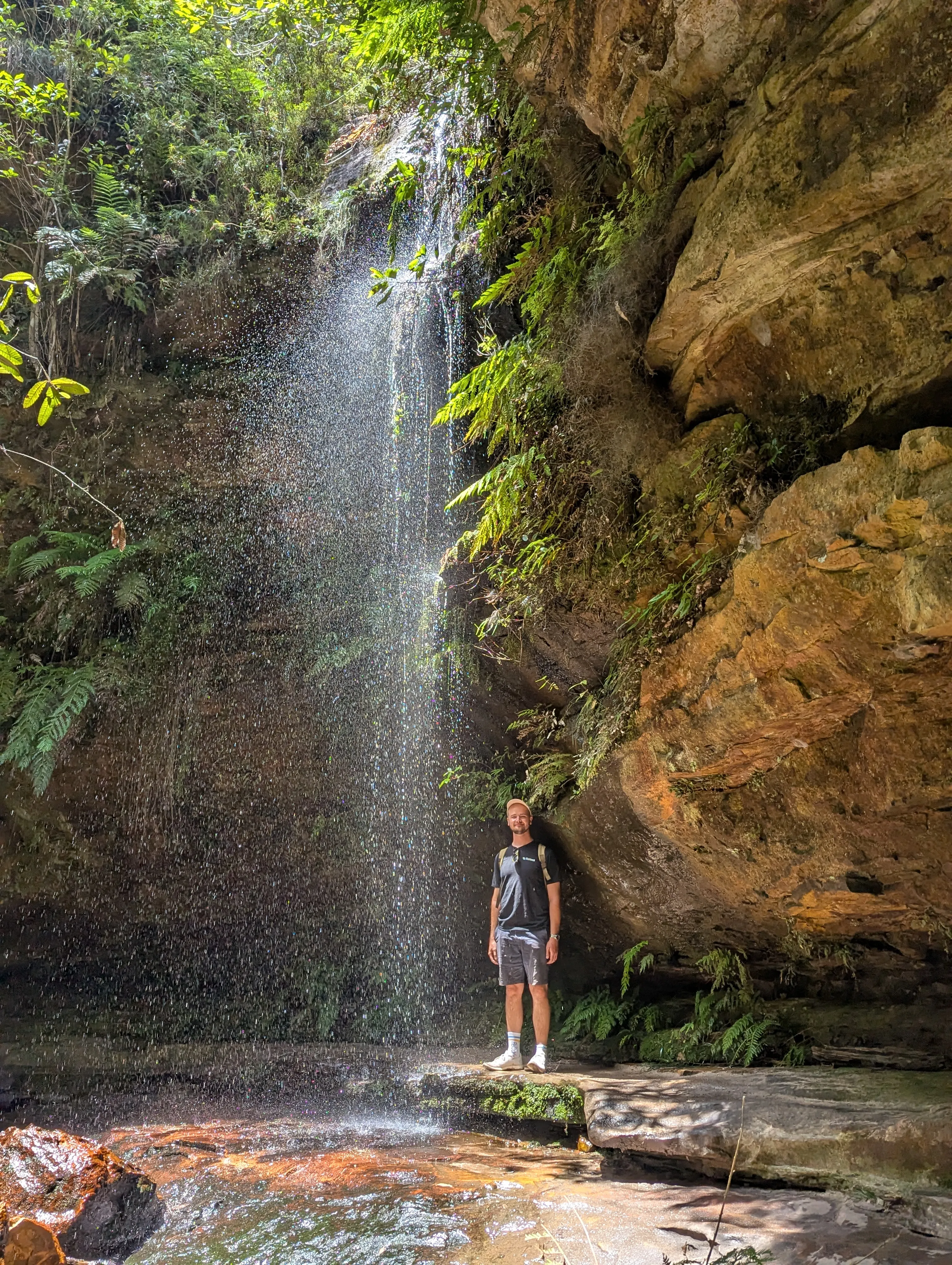Me standing under a waterfall.